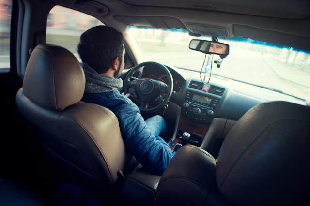 man driving car