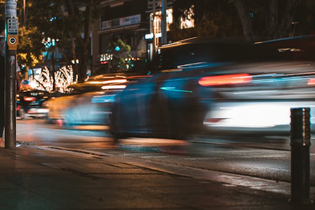 cars speeding past at night